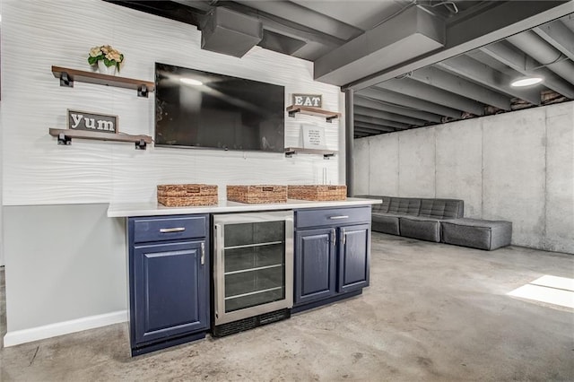 interior space featuring baseboards, concrete flooring, beverage cooler, and a dry bar