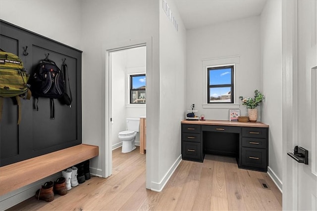 bathroom with visible vents, toilet, baseboards, and hardwood / wood-style floors