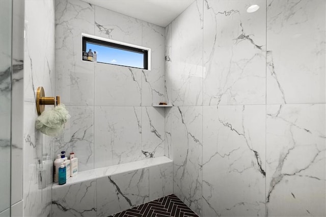 full bath with a marble finish shower