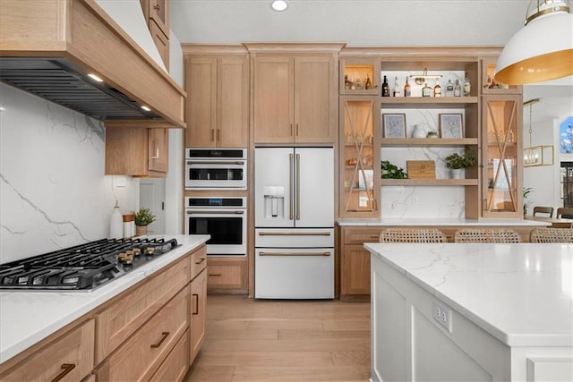 kitchen featuring white appliances, premium range hood, open shelves, light wood-style floors, and backsplash