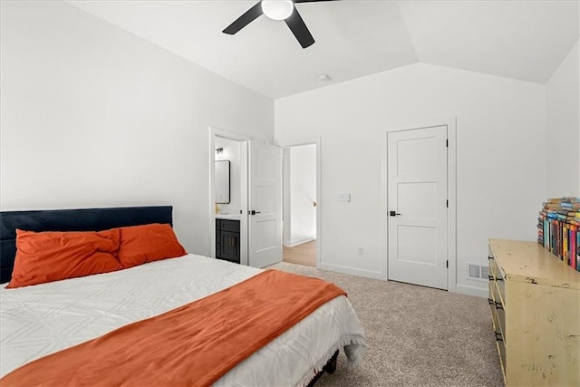 bedroom with carpet, visible vents, baseboards, vaulted ceiling, and connected bathroom