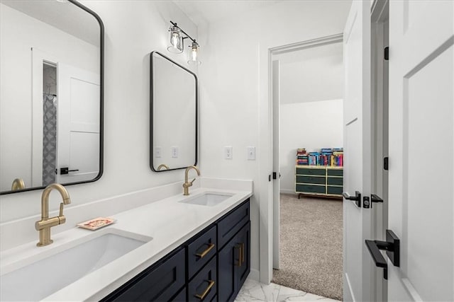 bathroom with a sink, a walk in closet, marble finish floor, and double vanity