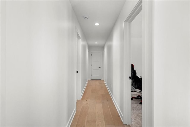 hall with recessed lighting, light wood-style flooring, and baseboards