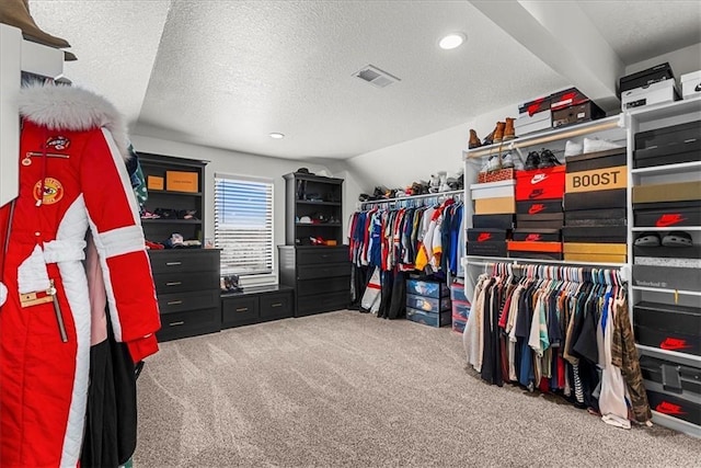 walk in closet featuring visible vents and carpet