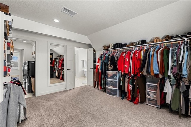 spacious closet featuring visible vents and carpet floors