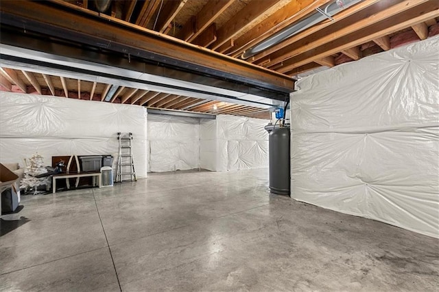 unfinished basement featuring gas water heater