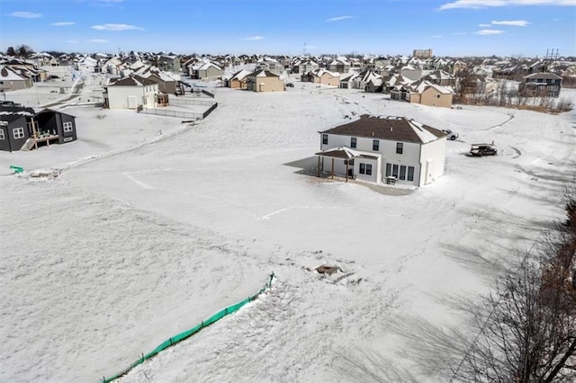 snowy aerial view with a residential view