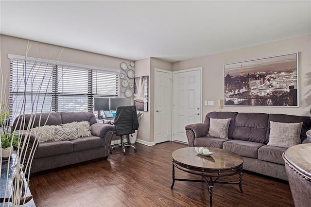 living area featuring dark wood-type flooring and baseboards