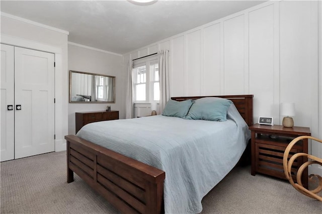 carpeted bedroom featuring crown molding and a decorative wall