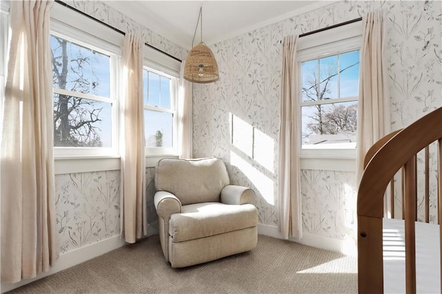 living area featuring wallpapered walls, carpet, and baseboards