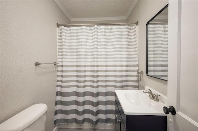 full bathroom featuring crown molding, vanity, toilet, and a textured ceiling