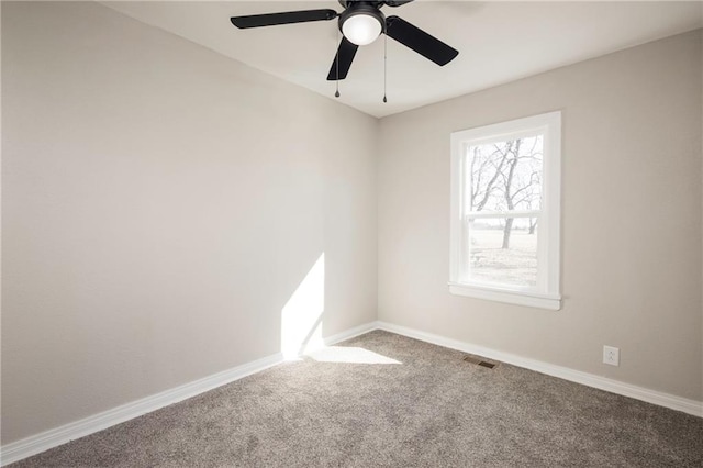 carpeted empty room with visible vents and baseboards