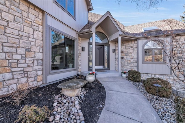 property entrance featuring stone siding and roof with shingles