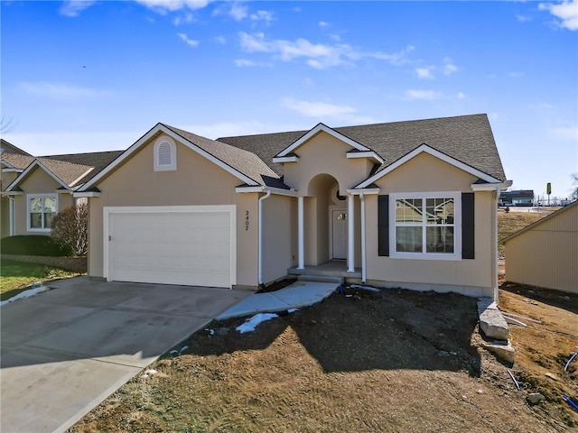 ranch-style home featuring a garage, concrete driveway, a shingled roof, and stucco siding