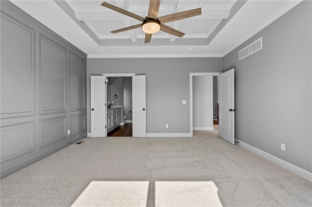 carpeted bedroom featuring baseboards, visible vents, coffered ceiling, and beam ceiling