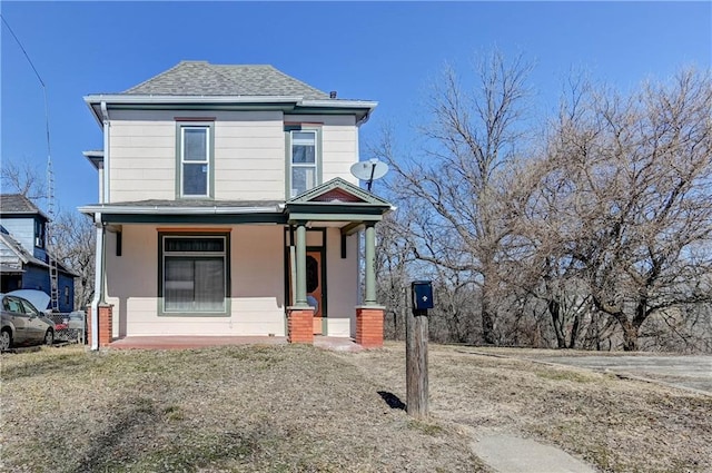 view of front of house featuring a porch and roof with shingles