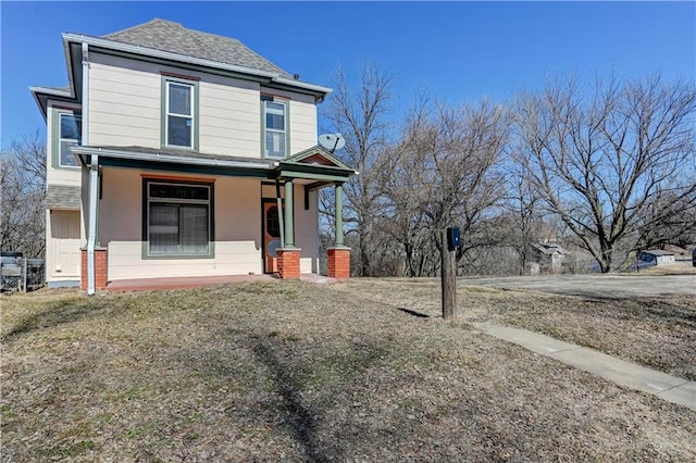 view of front of home with covered porch and a shingled roof