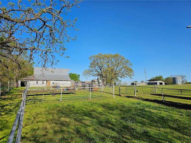 view of yard featuring fence and a rural view