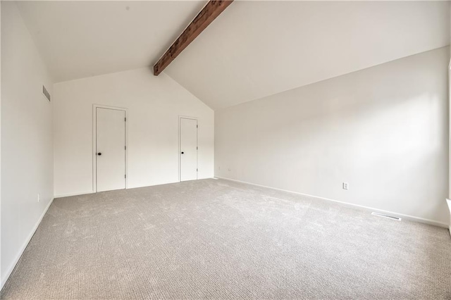 additional living space with vaulted ceiling with beams, carpet, visible vents, and baseboards