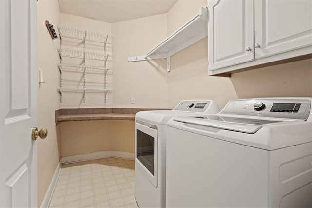 washroom featuring cabinet space, baseboards, a textured ceiling, light floors, and washing machine and dryer