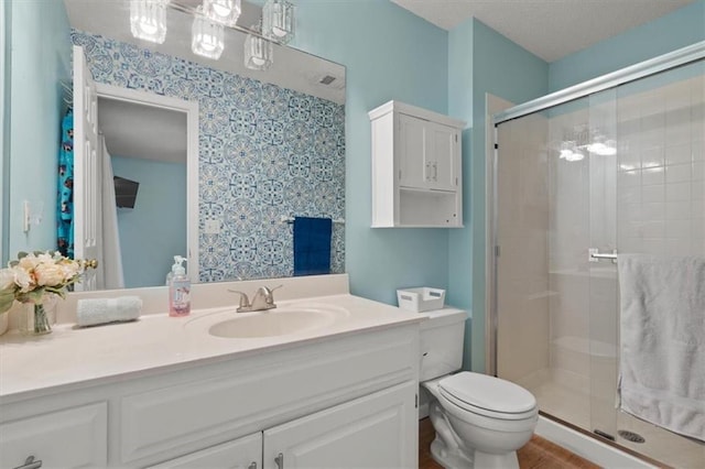 full bath with toilet, a stall shower, and vanity