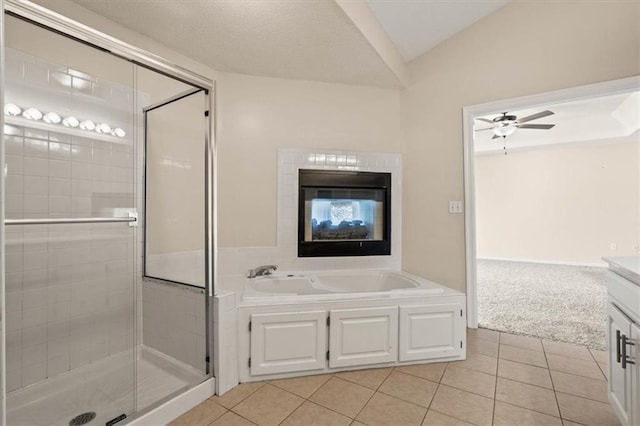 bathroom featuring a garden tub, ceiling fan, tile patterned flooring, and a shower stall