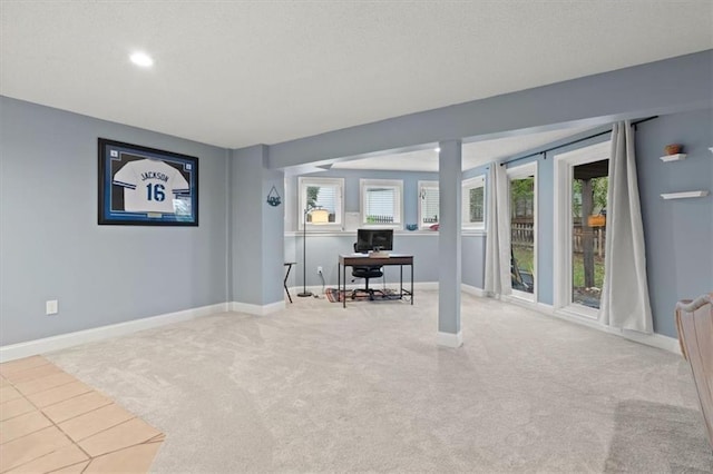 interior space with carpet floors, baseboards, and a wealth of natural light