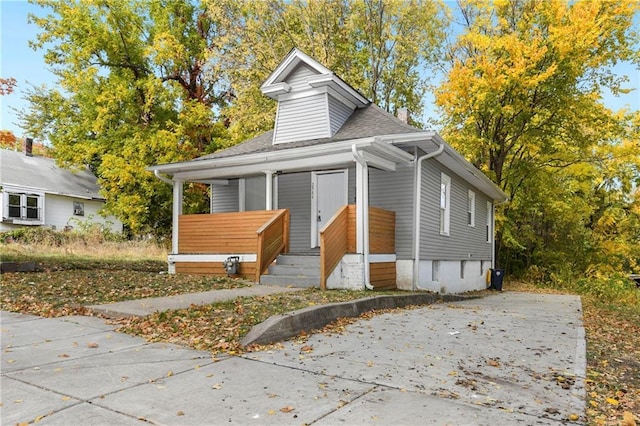 bungalow-style house featuring roof with shingles