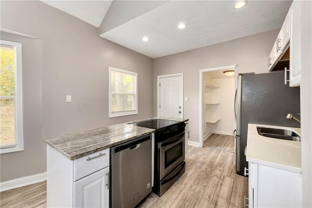 kitchen featuring a healthy amount of sunlight, white cabinets, and stainless steel appliances