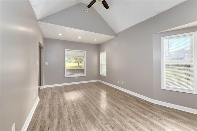 unfurnished room featuring ceiling fan, light wood-type flooring, vaulted ceiling, and baseboards