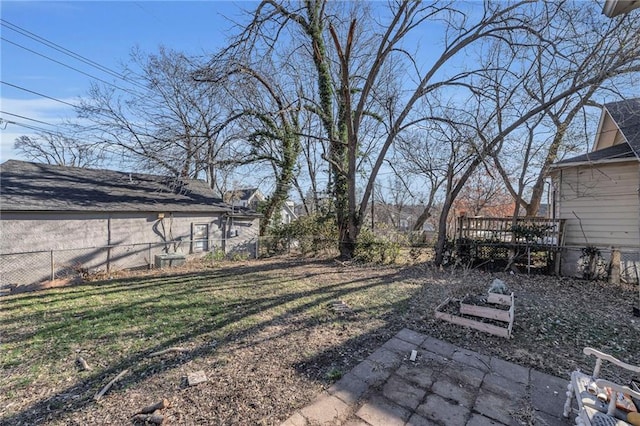 view of yard featuring a patio area, a fenced backyard, and a wooden deck