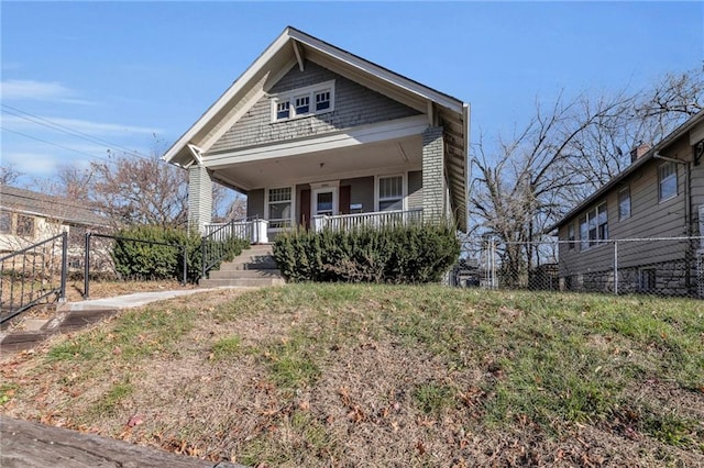 view of front of home featuring a porch and fence