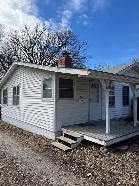 view of front of property with covered porch and a chimney