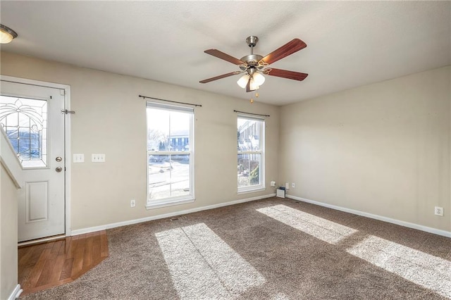 interior space featuring a ceiling fan and baseboards