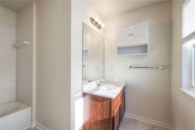 bathroom with a wealth of natural light, vanity, and baseboards