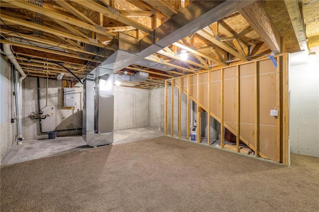 unfinished basement with electric panel and heating unit