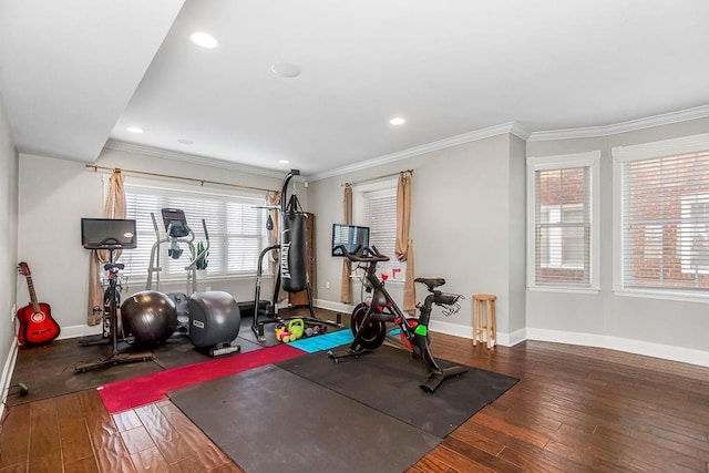 exercise room featuring baseboards, ornamental molding, dark wood-type flooring, and recessed lighting