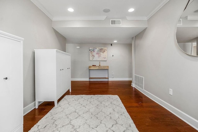 spare room with baseboards, visible vents, and dark wood finished floors