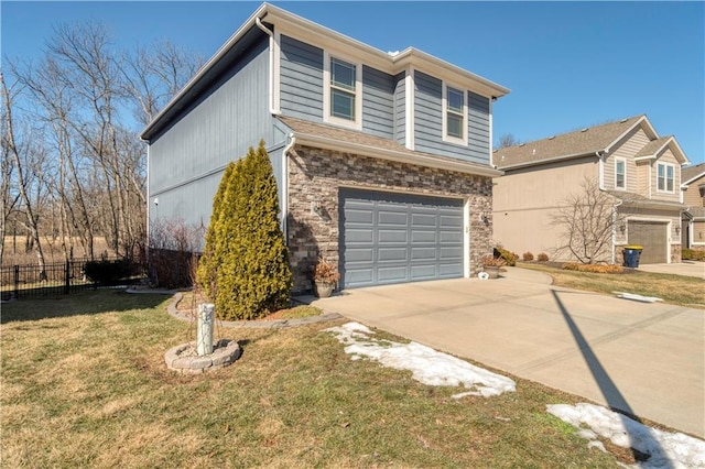 view of front of property with stone siding, driveway, an attached garage, and fence