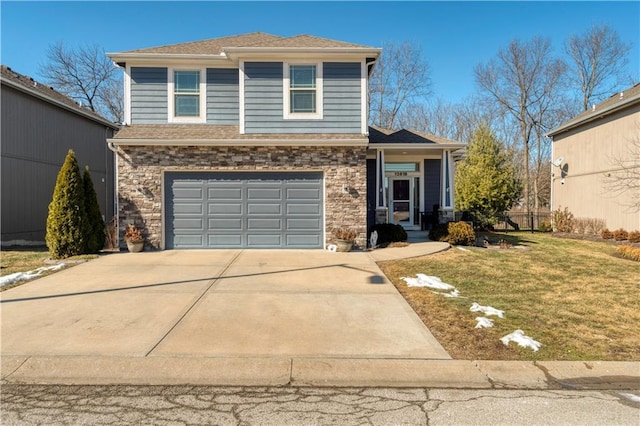 view of front of property featuring an attached garage, stone siding, a front yard, and driveway