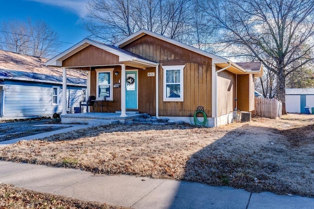 view of front of property with a porch and fence