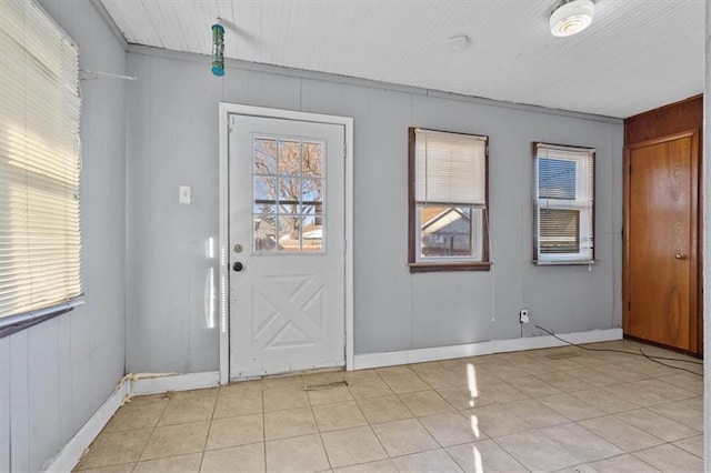 entrance foyer with light tile patterned floors and baseboards