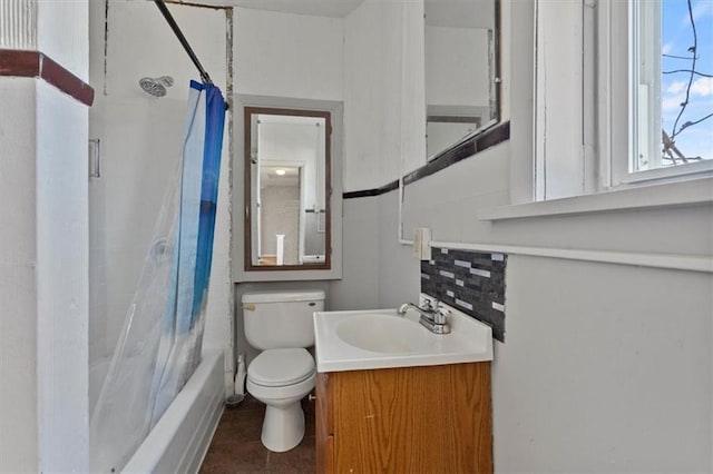 bathroom featuring shower / bath combination with curtain, vanity, toilet, and tasteful backsplash