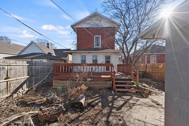 back of house featuring a fenced backyard and a wooden deck