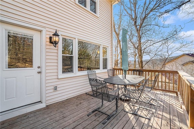 wooden deck featuring outdoor dining area