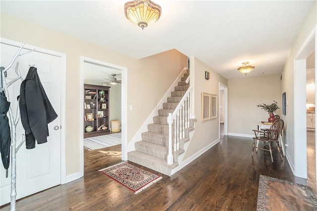 entryway featuring stairs, wood finished floors, and baseboards