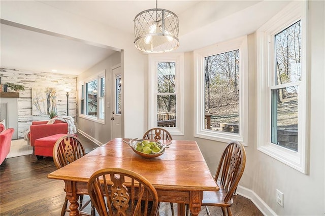 dining area featuring baseboards and wood finished floors