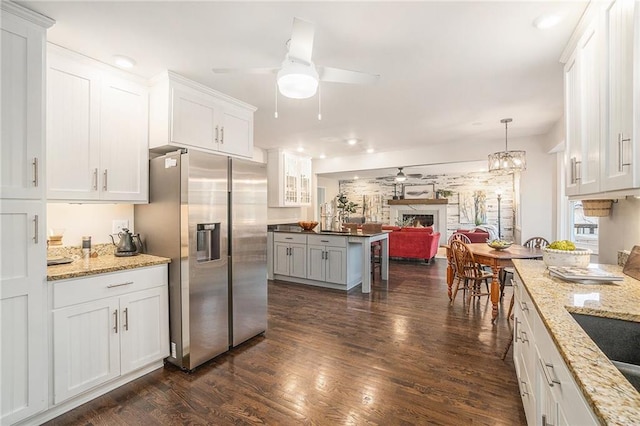 kitchen featuring dark wood-type flooring, a ceiling fan, open floor plan, white cabinetry, and stainless steel fridge with ice dispenser