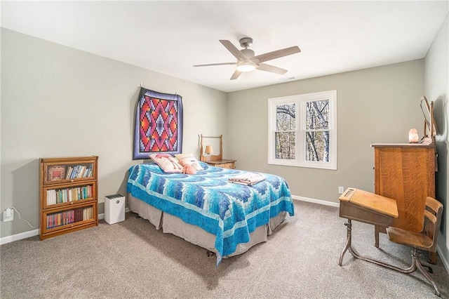 carpeted bedroom with a ceiling fan and baseboards