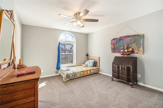 carpeted bedroom featuring baseboards and ceiling fan